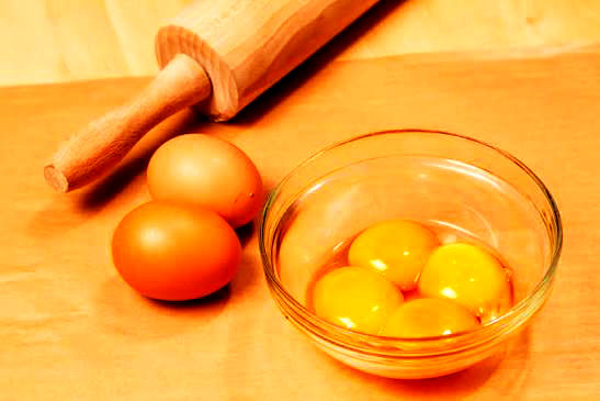 Eggs and a rolling pin on a cutting board